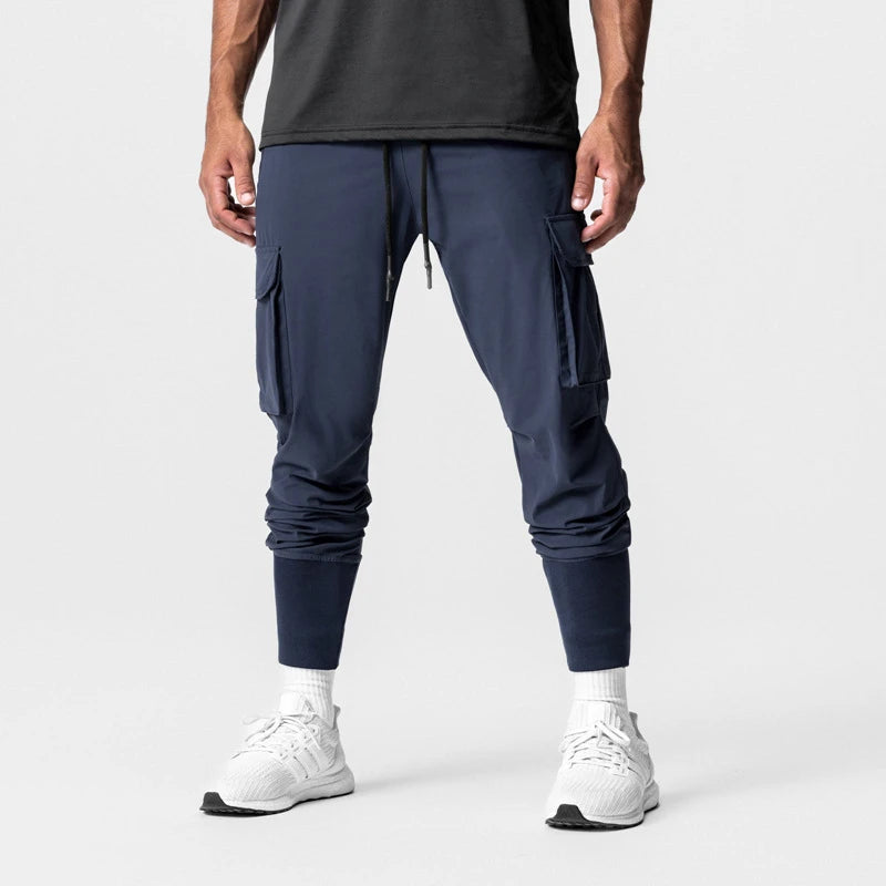 Men's sports pants in cargo style, navy color, featuring drawstring closure and side pockets, ideal for active training.