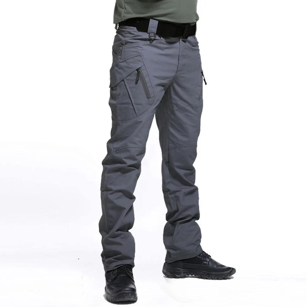 Gray tactical pants worn by a person on a white background
