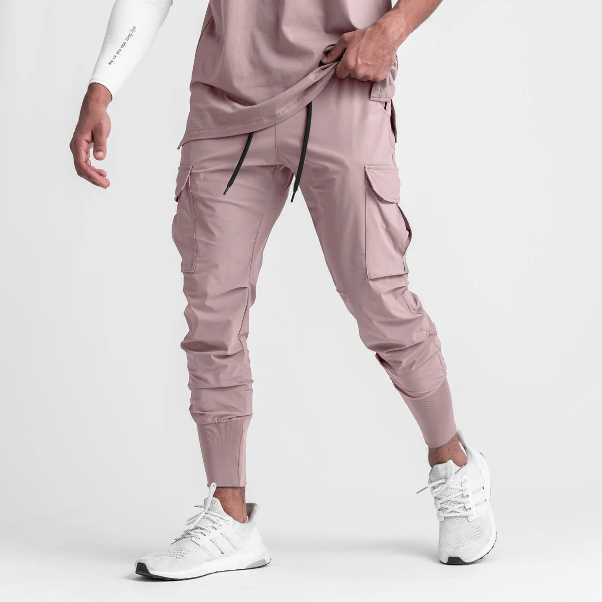 Men's sports pants in cargo style, featuring a drawstring closure and elastic fabric for comfort during workouts.