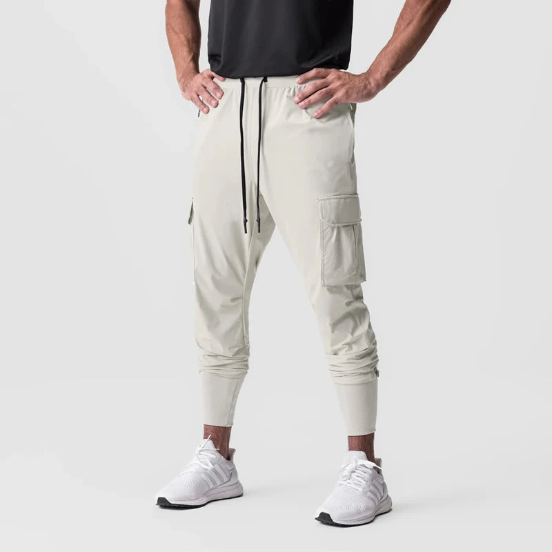 Men's sports pants cargo style in light color with drawstring closure and cargo pockets, perfect for training and activities.