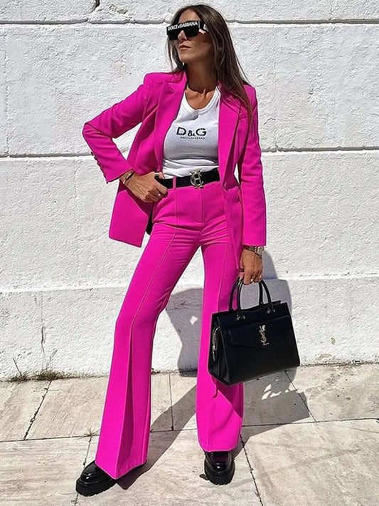 A woman dressing power suit on dark pink color