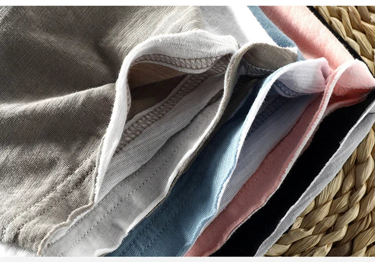 Stack of folded clothes in a woven basket