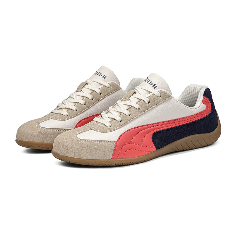 Pair of sneakers with beige, red, and navy design on a white background