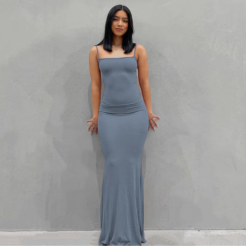 Model wearing a gray ankle-length slip dress with spaghetti straps against a plain background.