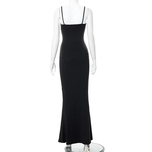 Back view of a sleek ankle-length black slip dress with spaghetti straps and a trumpet silhouette.