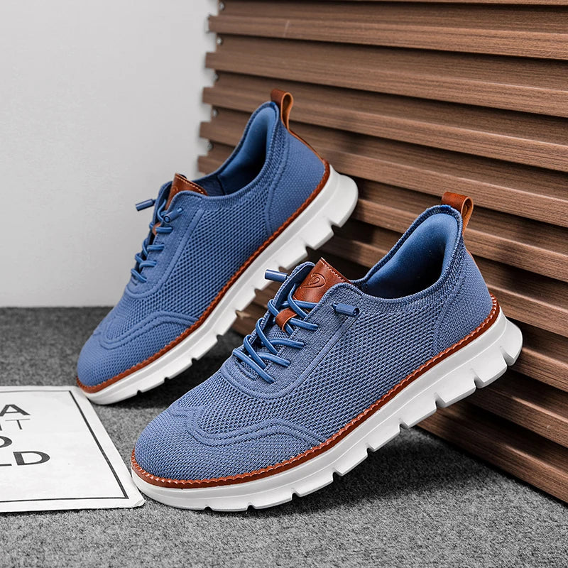 Blue sneakers with white soles and brown accents on a gray surface with wooden slats in the background.
