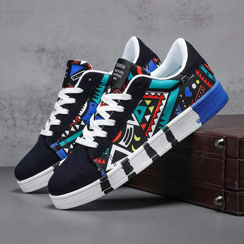 Colorful patterned sneakers on a gray surface with a brown suitcase.