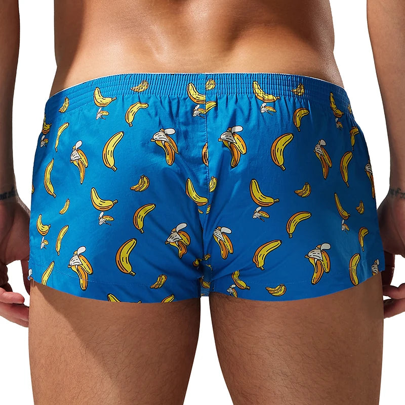A person wearing bright blue boxer briefs with an all-over yellow banana print, shown from the back against a plain white background.