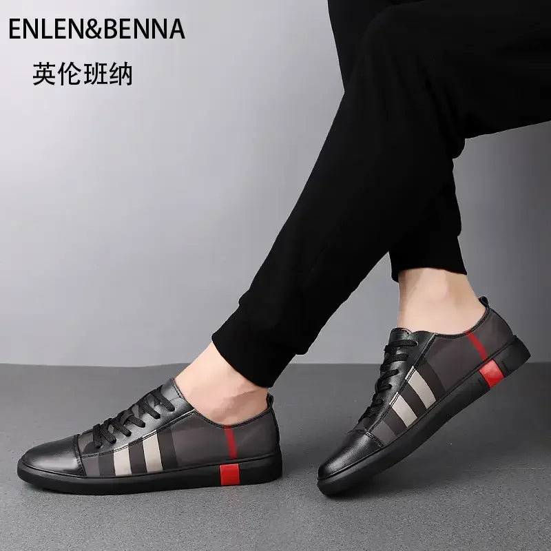 Black leather shoes with red and gray stripes worn by a person on a gray background, featuring the brand 'ENLEN&BENNA'.