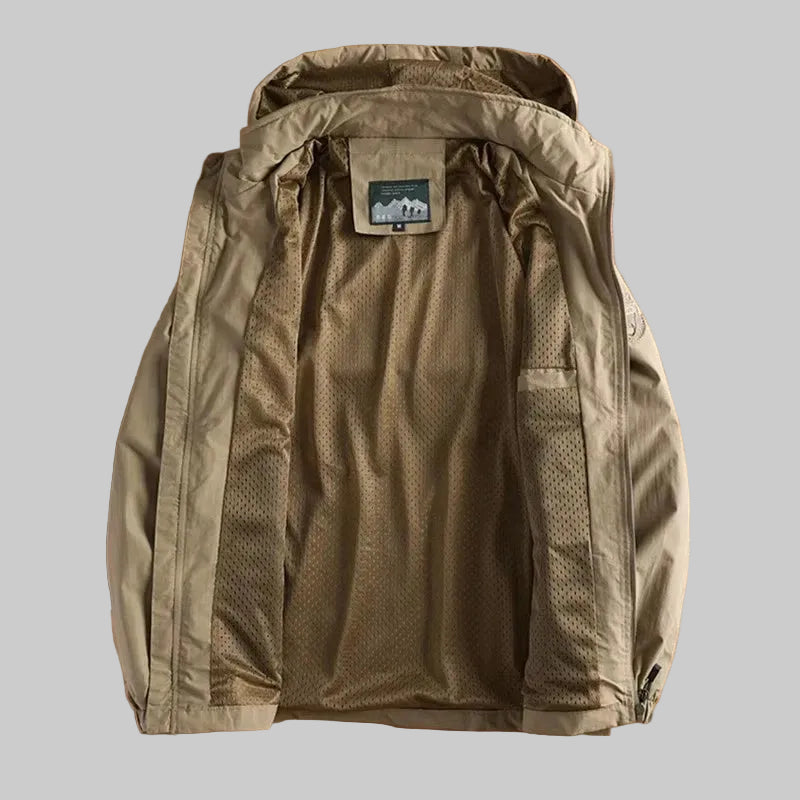 Khaki jacket with a hood on a wooden surface