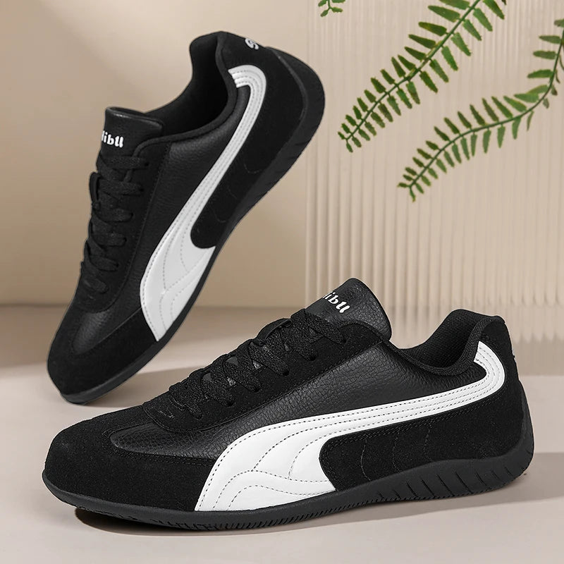 Black and white sneakers with a brand logo on a neutral background