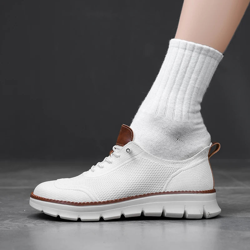 White sneaker with brown accents worn with a white sock on a dark background