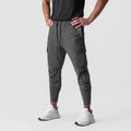 Men's cargo style sports pants in gray, featuring a drawstring waist and side pockets, perfect for workouts and training.