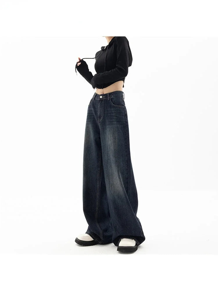 Person wearing a black top and wide-leg jeans on a white background