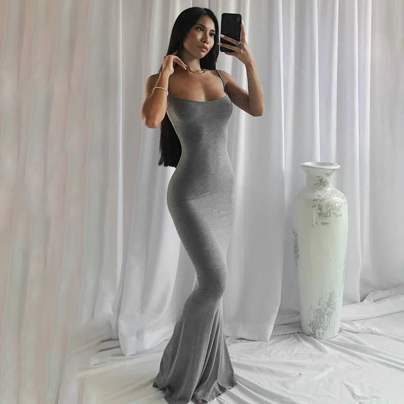 Model wearing a gray ankle-length slip dress with spaghetti straps against a white backdrop.