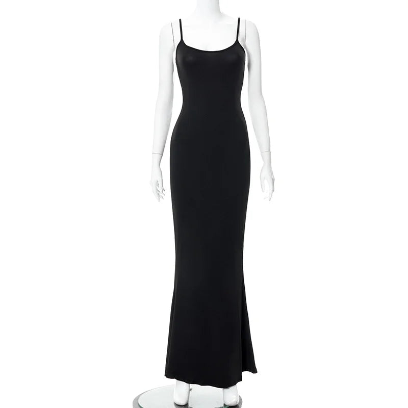Elegant black ankle-length slip dress on a mannequin, featuring spaghetti straps and a slim fit silhouette.