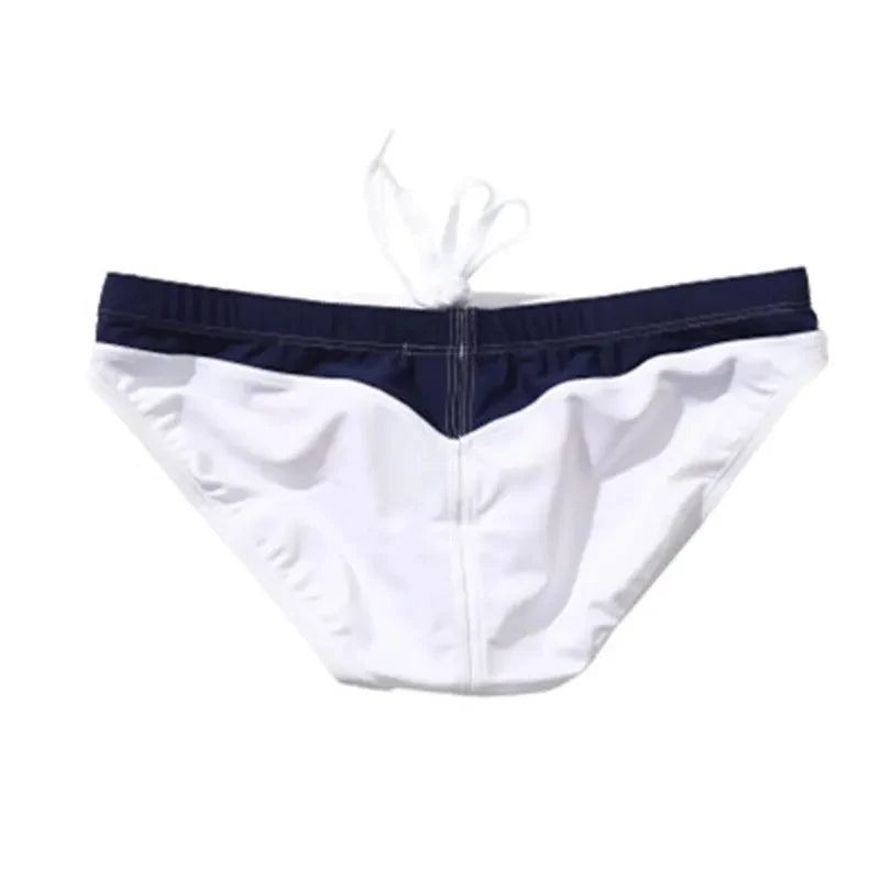 White swim briefs with navy waistband on a white background