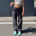 A person wearing Y2K retro loose jeans paired with a cropped top and green sneakers, showcasing streetwear style.