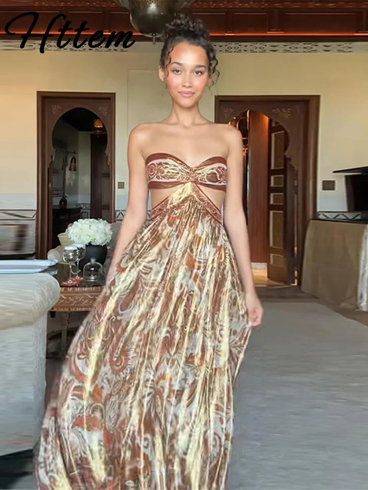 Elegant hollow out strapless dress on a model, showcasing a flowing design and sophisticated beach holiday style.