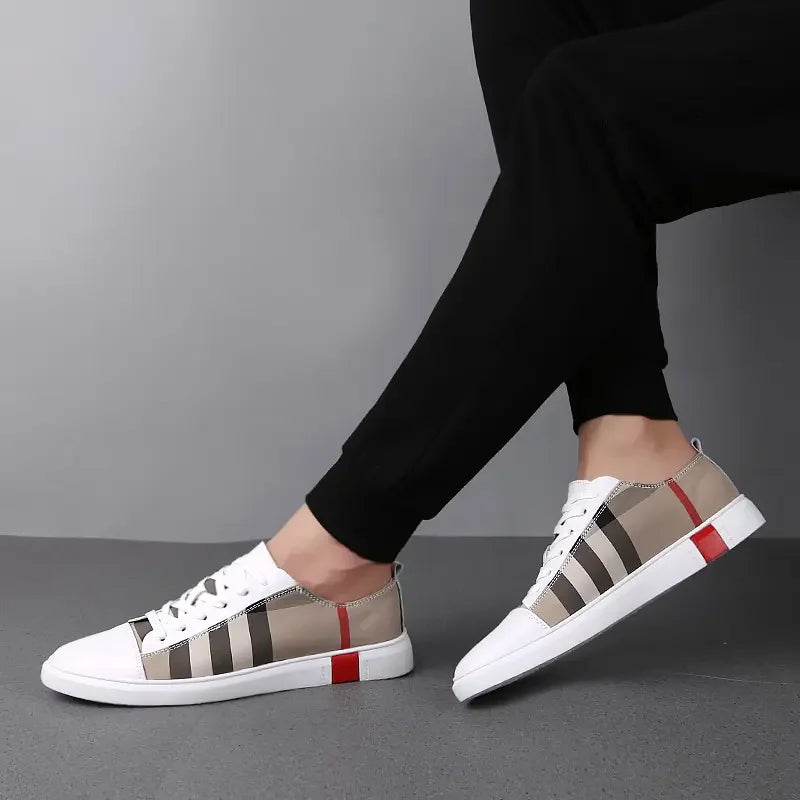 White sneakers with plaid pattern worn by a person on a gray background