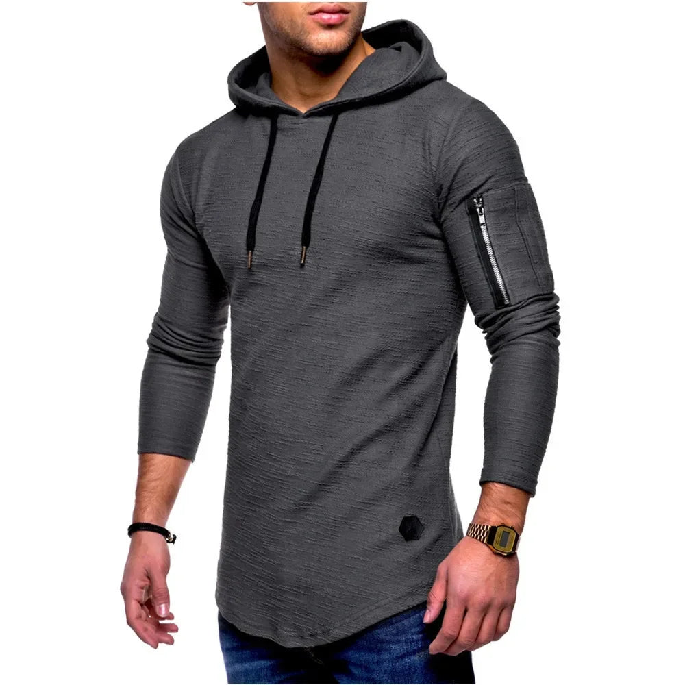 Man wearing a gray hoodie with zippers on sleeves against a white background