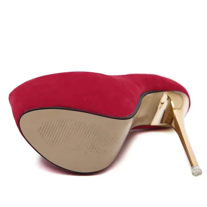 Red high-heeled shoe with gold heel on a white background